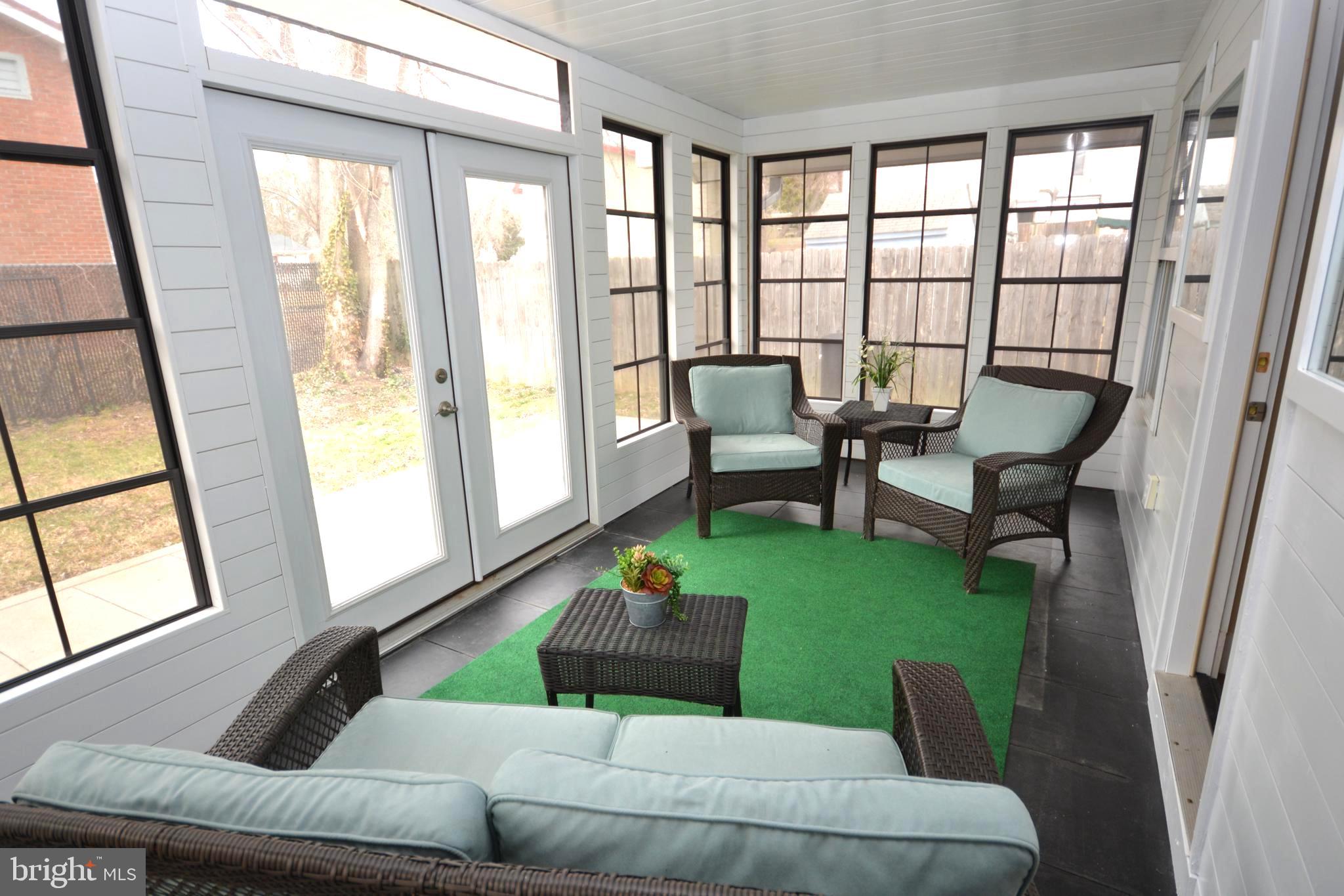 106 B Conner Street St. Michaels, MD 21663 - Photo 16 of 27 a living room with furniture and a floor to ceiling window