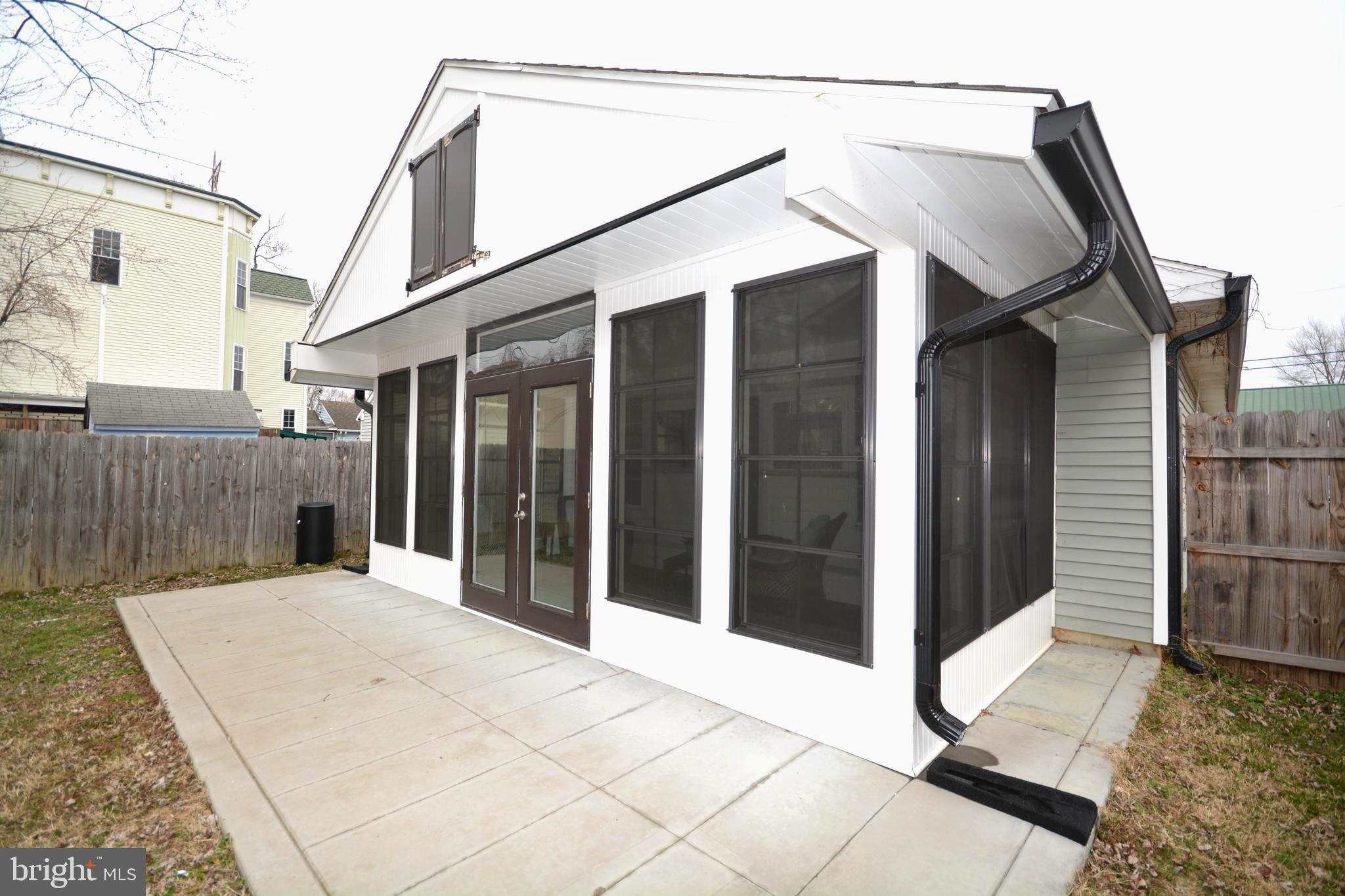 106 B Conner Street St. Michaels, MD 21663 - Photo 24 of 27 a view of a house with a door and wooden bench