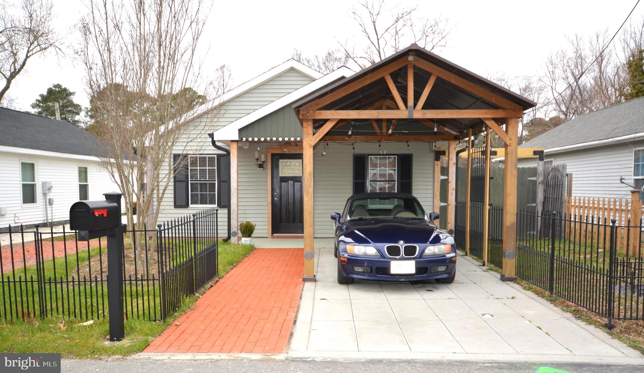 106 B Conner Street St. Michaels, MD 21663 - Photo 3 of 27 a front view of a house with glass doors