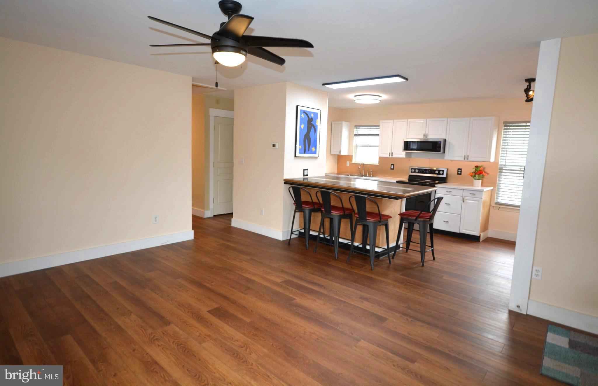 106 B Conner Street St. Michaels, MD 21663 - Photo 6 of 27 a view of a kitchen with workspace and wooden floor