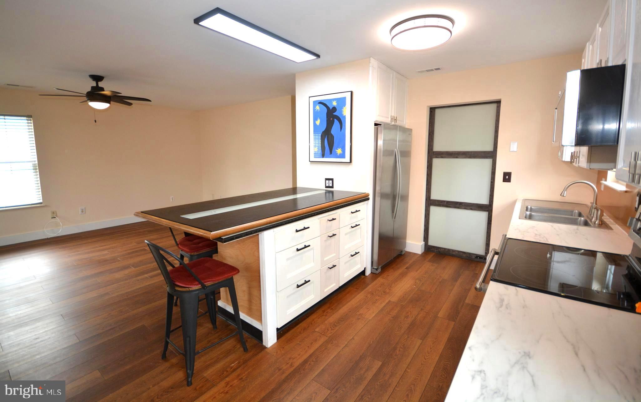 106 B Conner Street St. Michaels, MD 21663 - Photo 7 of 27 a spacious bathroom with a double vanity sink and a mirror