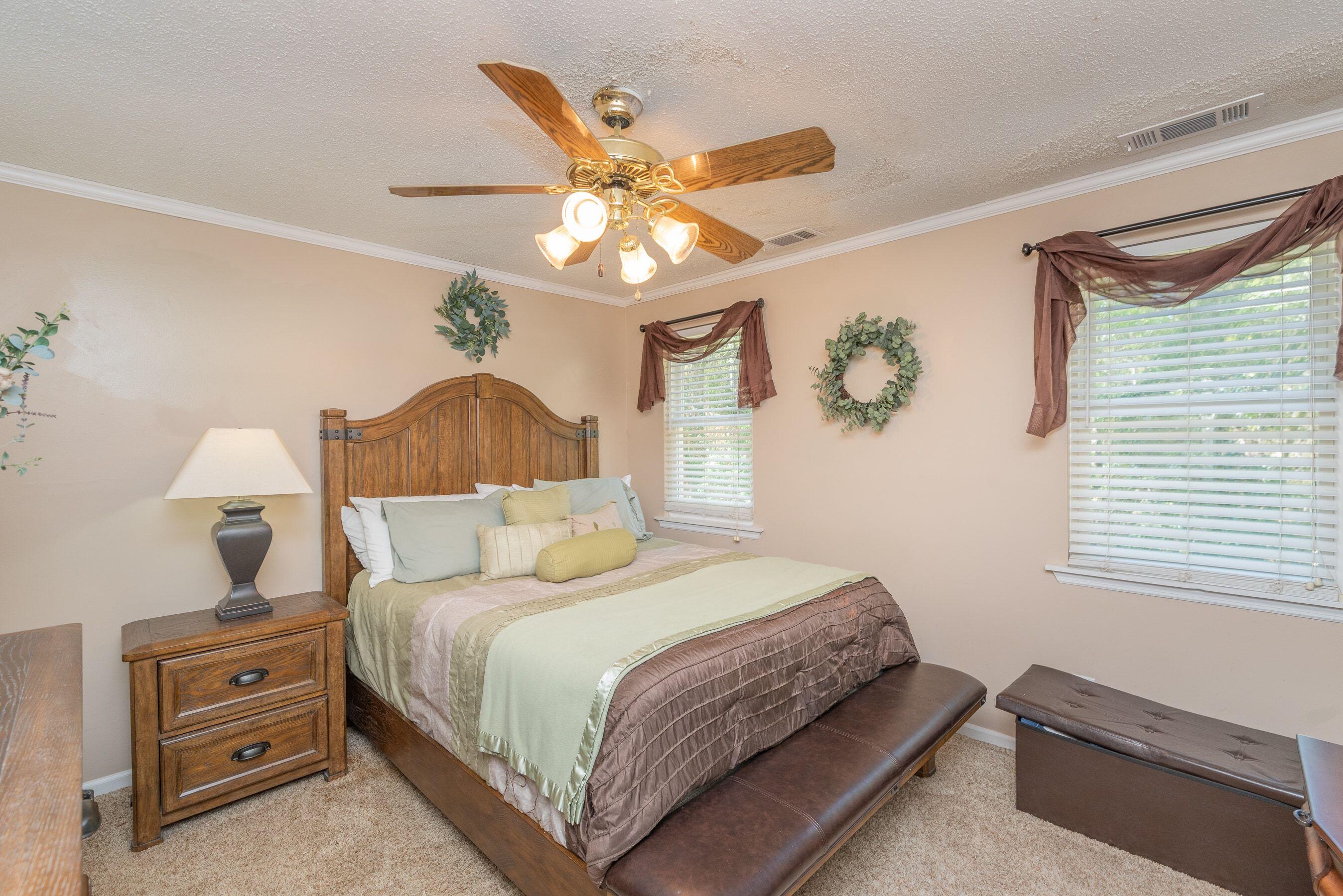 1117 Ridgemont Drive Aiken, SC 29803 - Photo 15 of 49 a bedroom with a bed and a chandelier