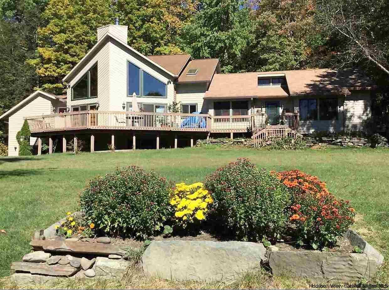 a front view of a house with a garden and porch