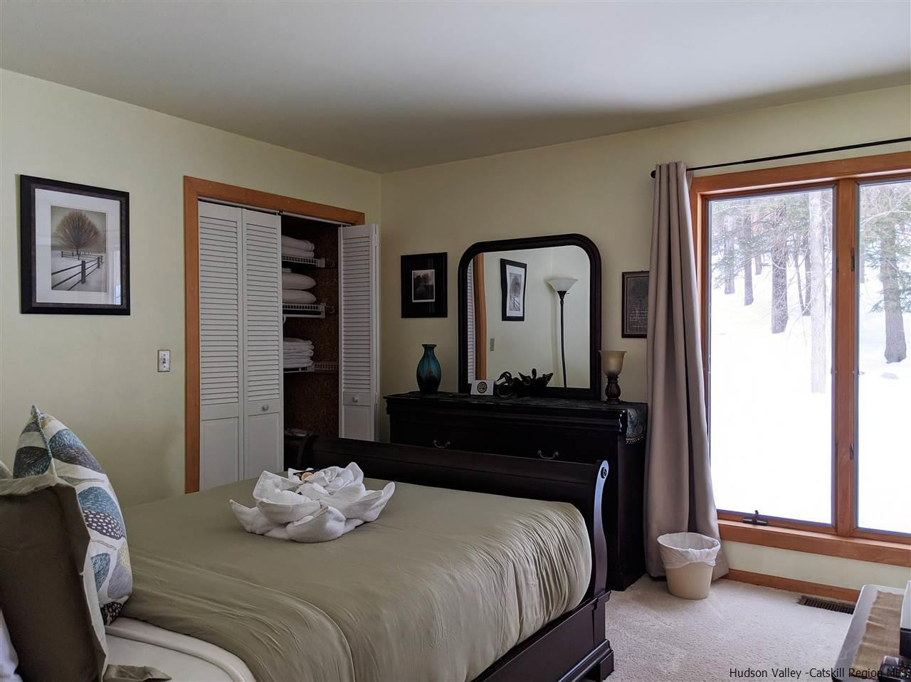 430 North Riverside Road Highland, NY 12528 - Photo 14 of 34 a bedroom with a bed and large windows