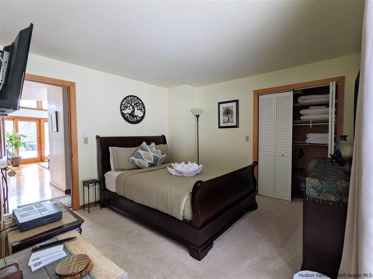 430 North Riverside Road Highland, NY 12528 - Photo 15 of 34 a large bedroom with a bed and a window