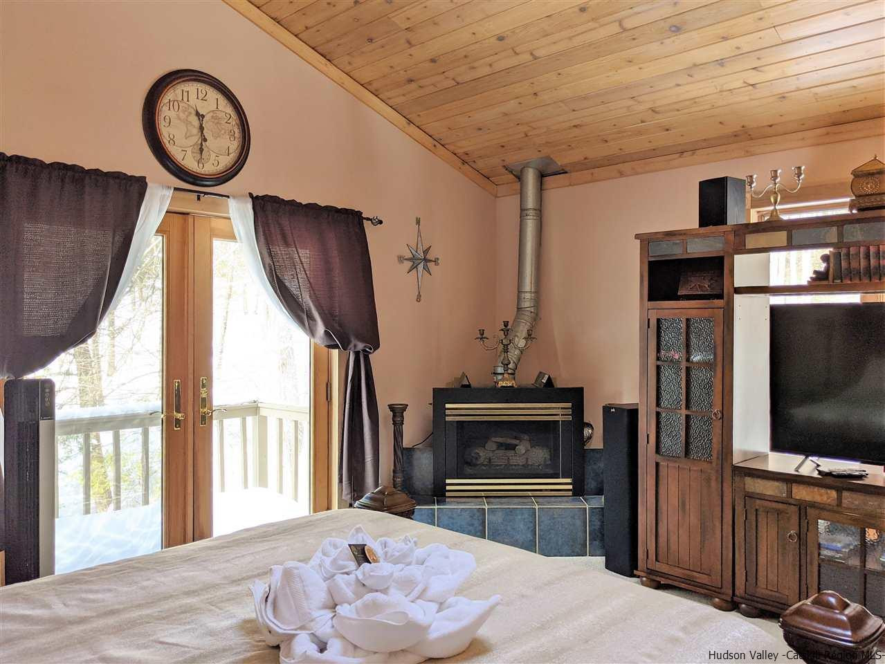 430 North Riverside Road Highland, NY 12528 - Photo 29 of 34 a living room with furniture a flat screen tv and a fireplace