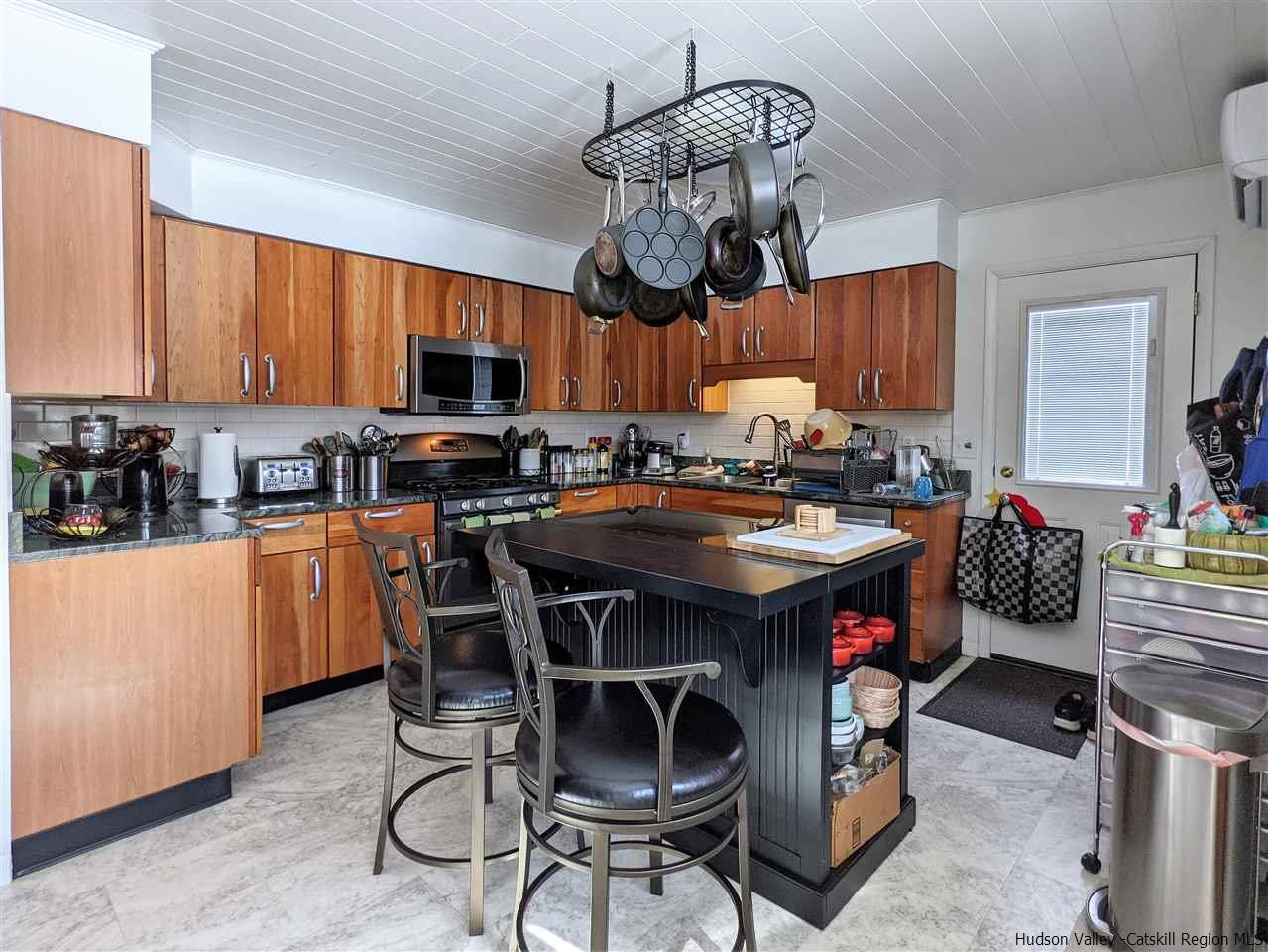 430 North Riverside Road Highland, NY 12528 - Photo 5 of 34 a kitchen with stainless steel appliances granite countertop a stove a sink dishwasher and a refrigerator with wooden cabinets