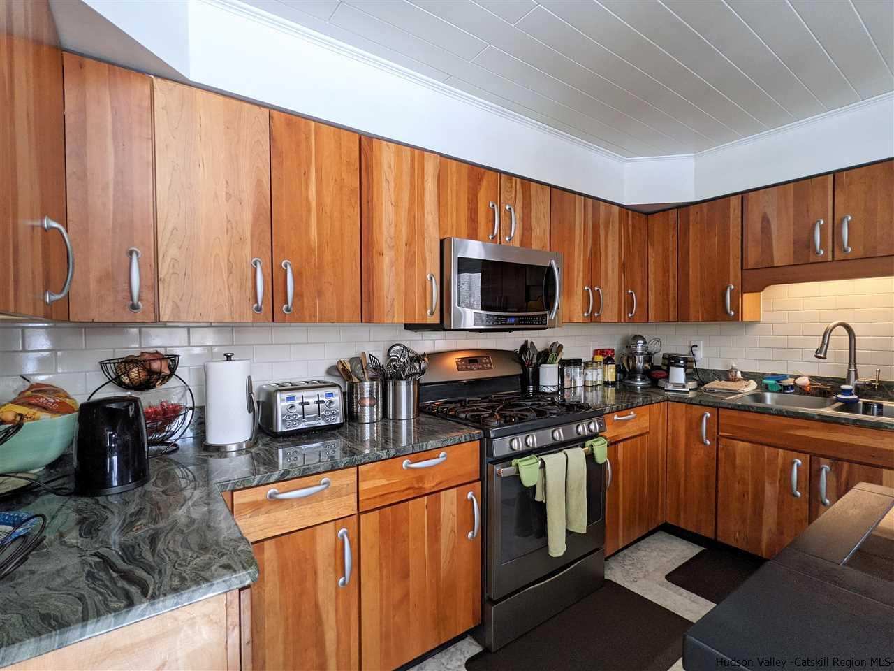 430 North Riverside Road Highland, NY 12528 - Photo 7 of 34 a kitchen with stainless steel appliances granite countertop a stove top oven a sink dishwasher and a microwave with wooden cabinets