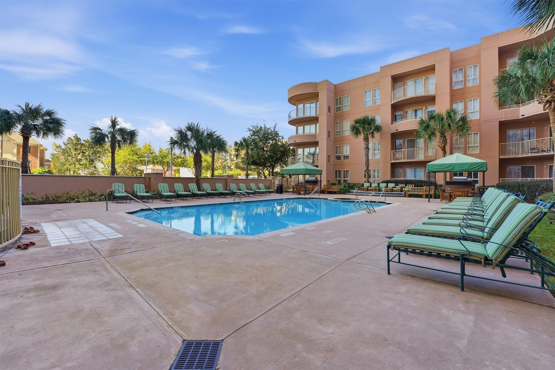 3505 Sage Road, Unit 208 Houston, TX 77056 - Photo 18 of 25 a view of a swimming pool with a lounge chairs