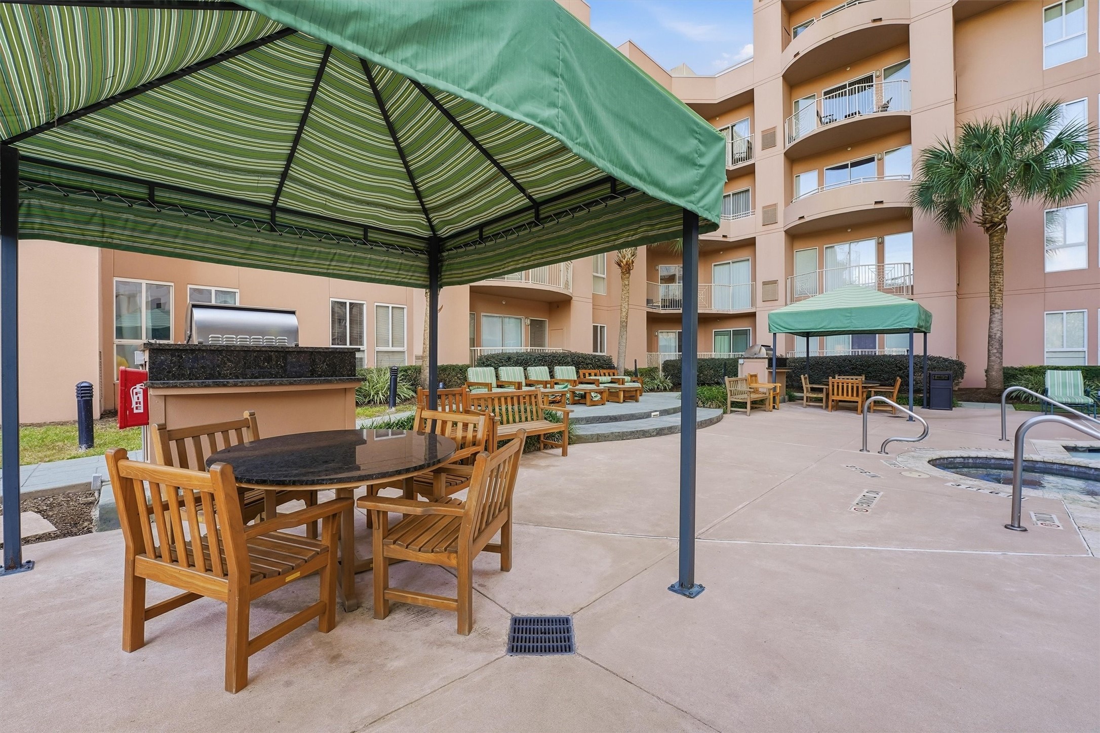 3505 Sage Road, Unit 208 Houston, TX 77056 - Photo 20 of 25 a view of a patio with a table and chairs under an umbrella