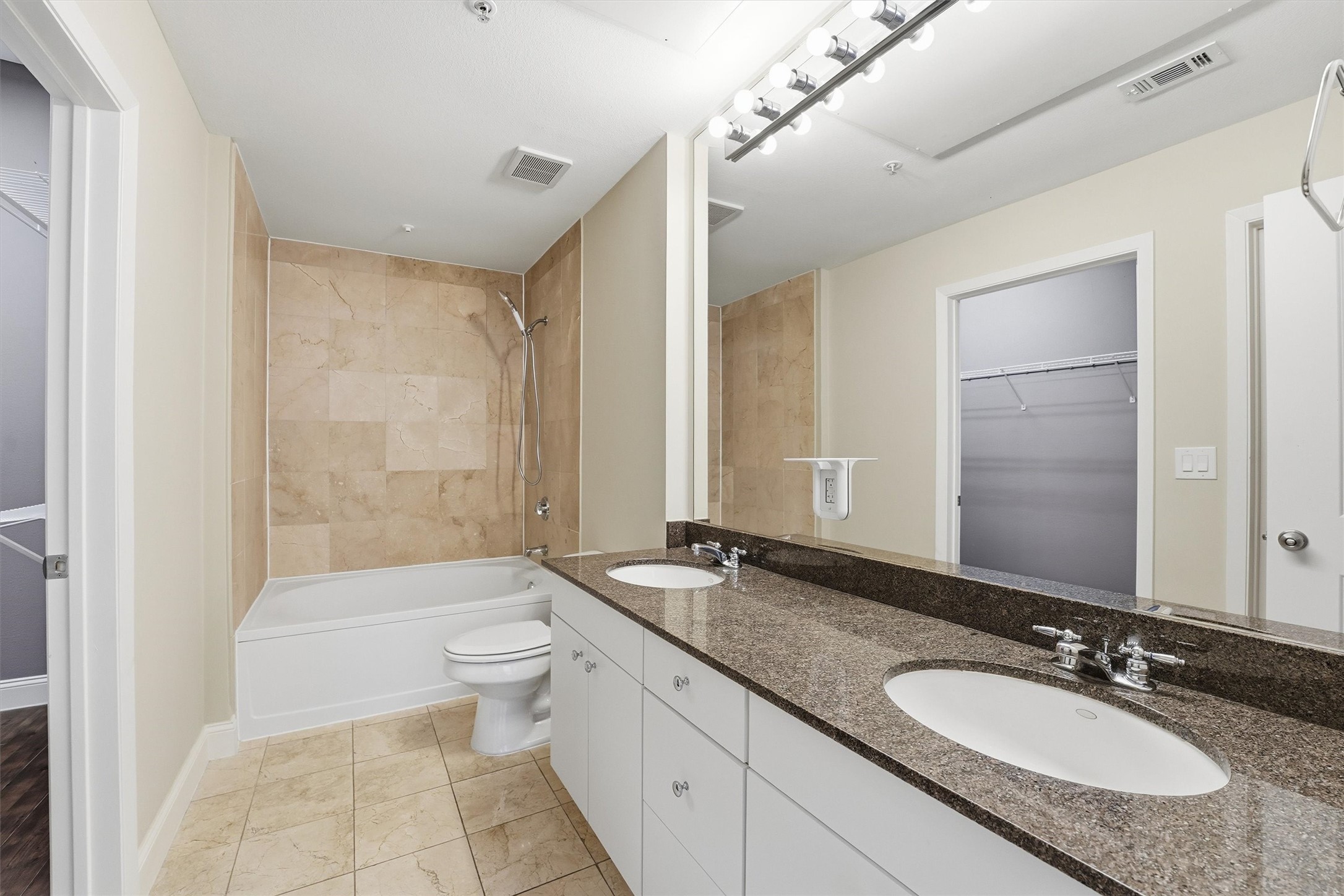 3505 Sage Road, Unit 208 Houston, TX 77056 - Photo 9 of 25 a bathroom with a granite countertop sink a toilet a mirror and shower