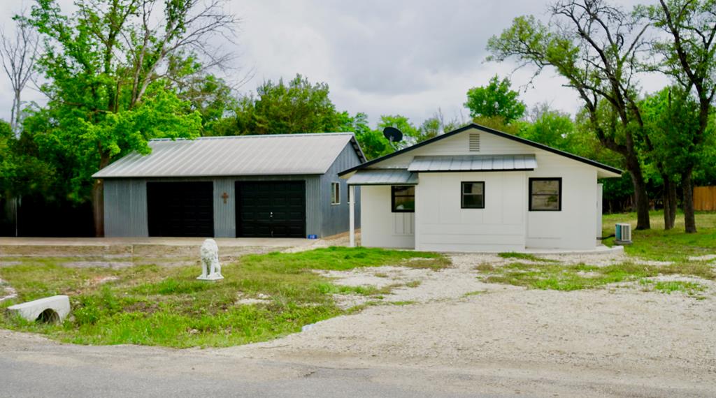 110 4th Street Ingram, TX 78025 - Photo 1 of 15 a front view of a house with a garden