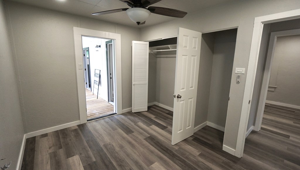 110 4th Street Ingram, TX 78025 - Photo 11 of 15 a view of an empty room with wooden floor and a window