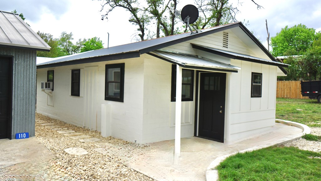 110 4th Street Ingram, TX 78025 - Photo 2 of 15 a view of a house with a yard