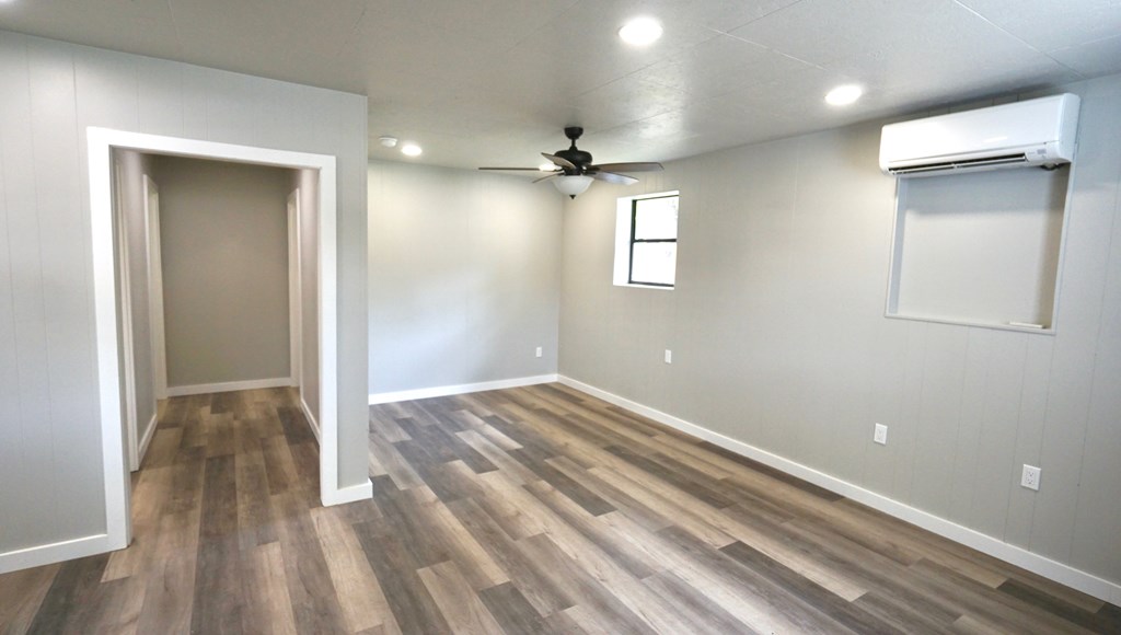 110 4th Street Ingram, TX 78025 - Photo 6 of 15 wooden floor in an empty room with a window