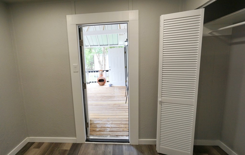 110 4th Street Ingram, TX 78025 - Photo 10 of 15 a view of a hallway with wooden floor and a bathroom