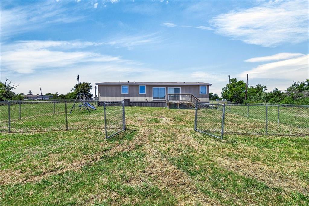 1129 Ragsdale Street Terrell, TX 75160 - Photo 15 of 29 open back porch, backyard is partially fenced with chain link fencing