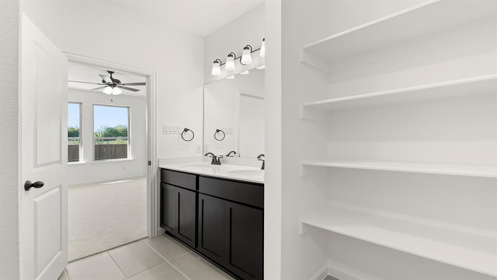 2516 YO Rnch Road Anna, TX 75409 - Photo 22 of 30 a bathroom with a double vanity sink mirror and bathtub
