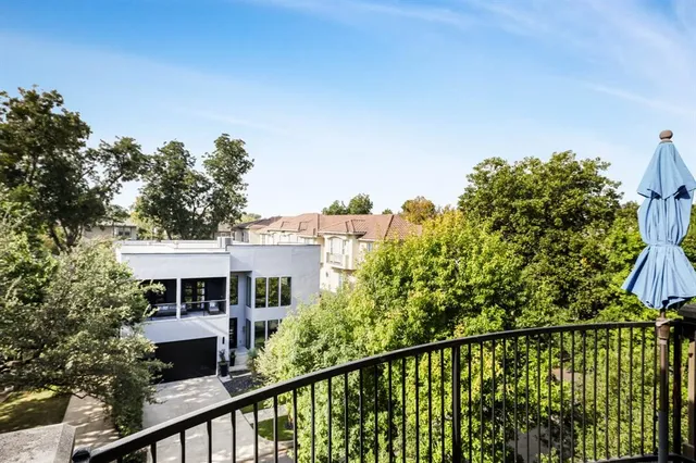 a view of a house with a street from a balcony