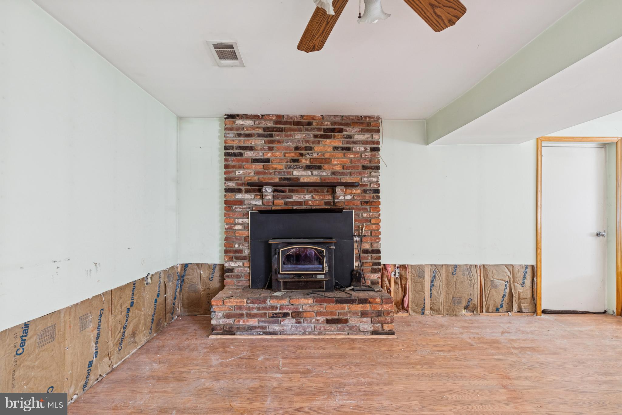7518 Harmans Road Harmans, MD 21077 - Photo 4 of 34 a living room with furniture and a fireplace
