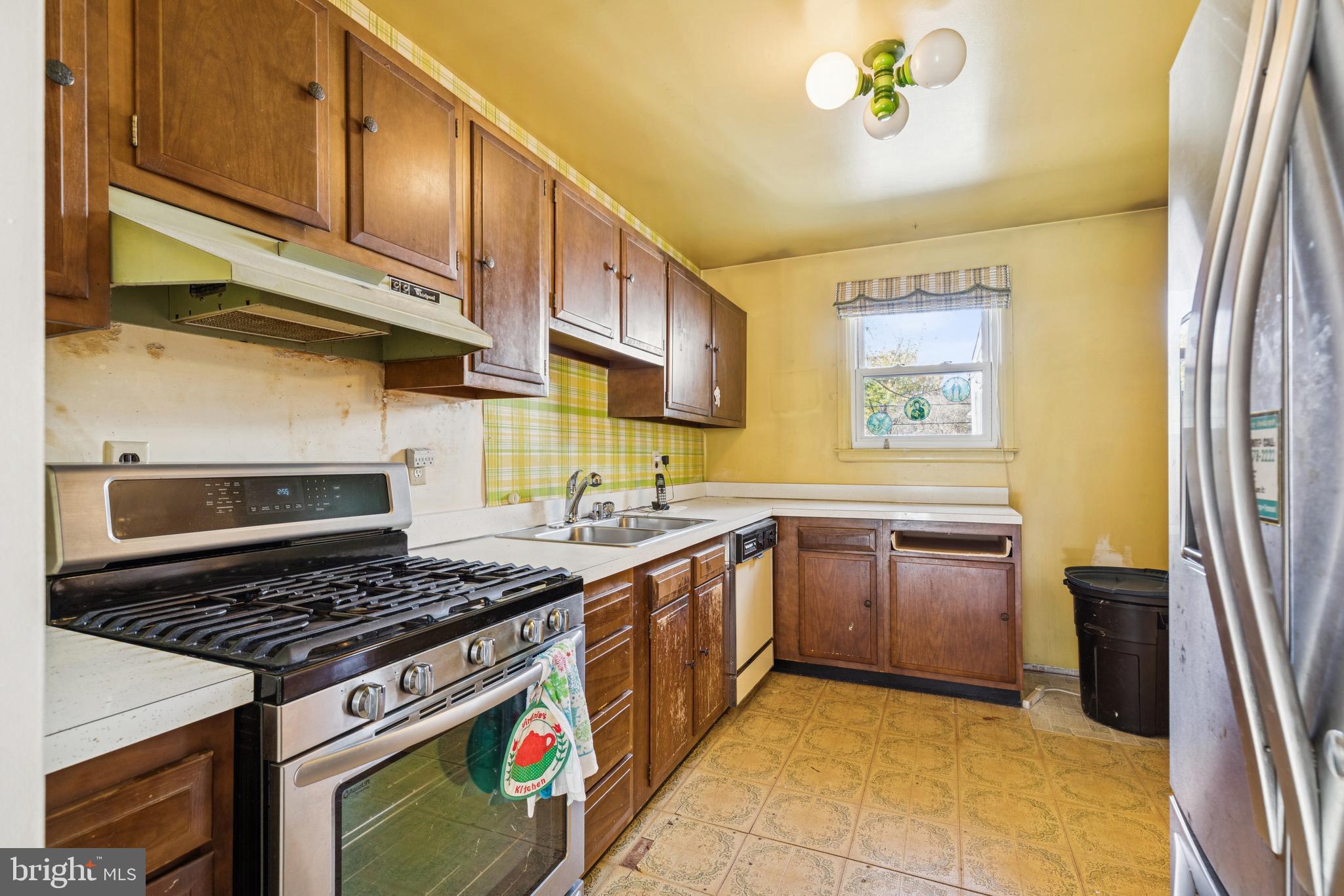7518 Harmans Road Harmans, MD 21077 - Photo 7 of 34 a kitchen with stainless steel appliances granite countertop a stove and a sink