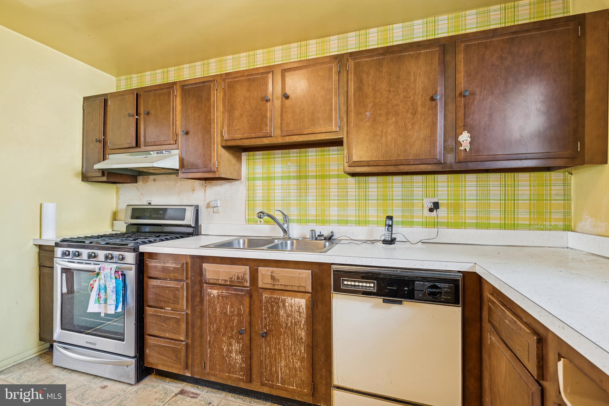 7518 Harmans Road Harmans, MD 21077 - Photo 8 of 34 a kitchen with stainless steel appliances granite countertop a sink a stove and cabinets
