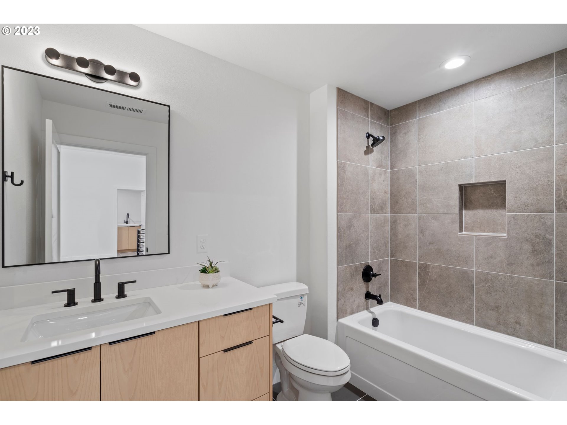 240 North 22nd Court Ridgefield, WA 98642 - Photo 30 of 34 a bathroom with a granite countertop sink a toilet a mirror a bathtub and shower