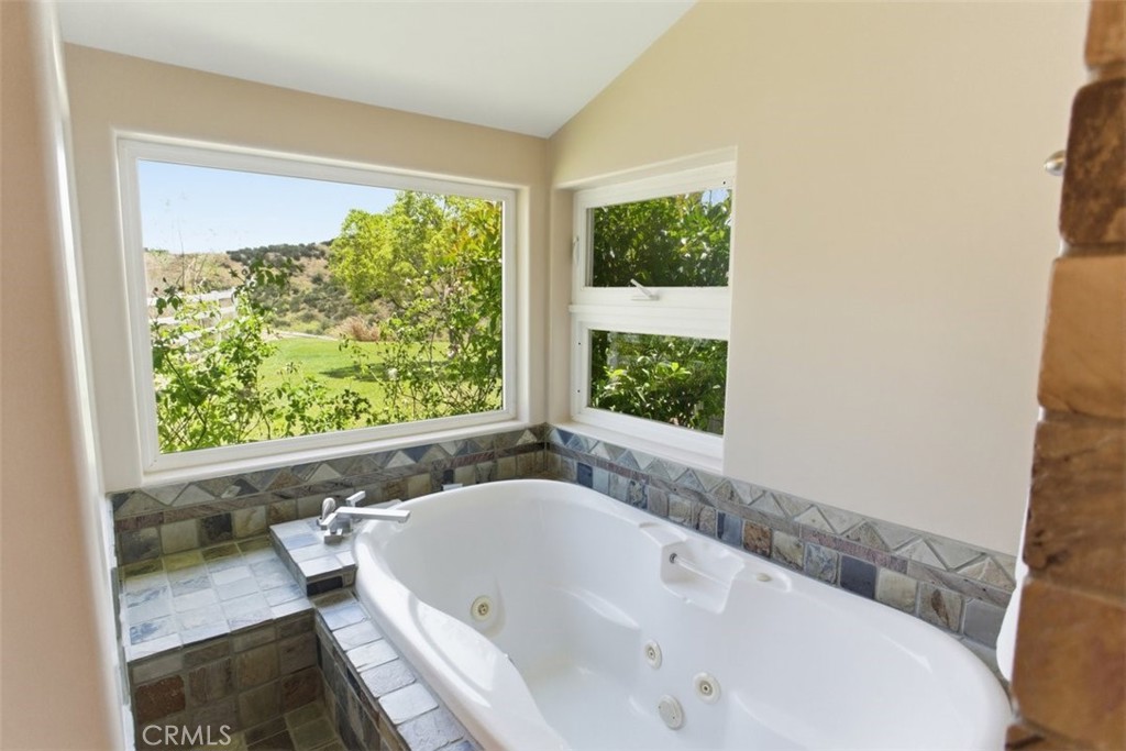 31233 Romero Canyon Road Castaic, CA 91384 - Photo 23 of 38 a bath tub sitting in a bathroom next to a window