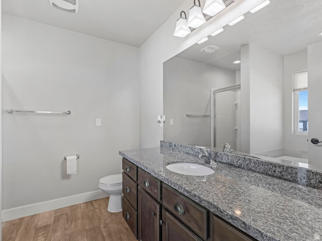 573 South Maxwell Drive Grantsville, UT 84029 - Photo 13 of 25 Full bathroom with a shower stall, vanity, light wood-style flooring, and a bath