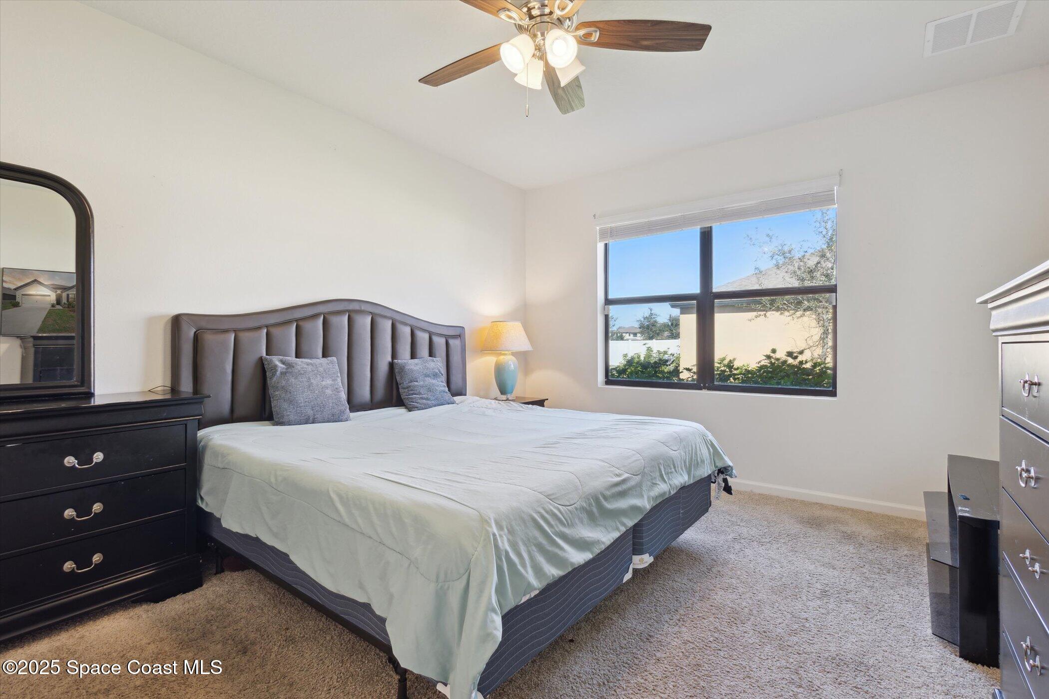 560 Lumber Jack Place Cocoa, FL 32927 - Photo 17 of 32 a bedroom with a bed and a window
