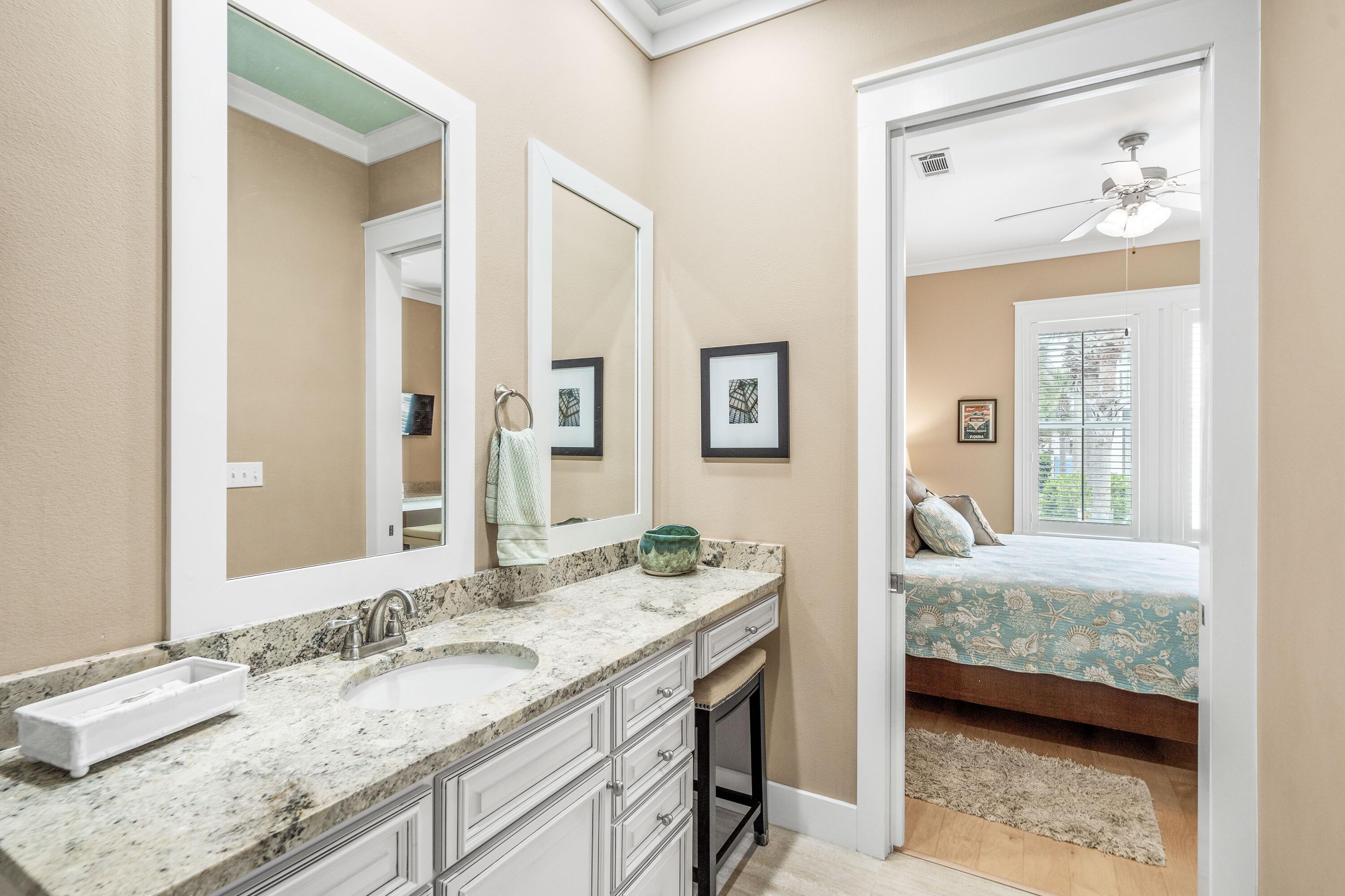 36 Moonlight Beach Lane Inlet Beach, FL 32461 - Photo 18 of 42 a en suite bathroom with a granite countertop sink and a mirror