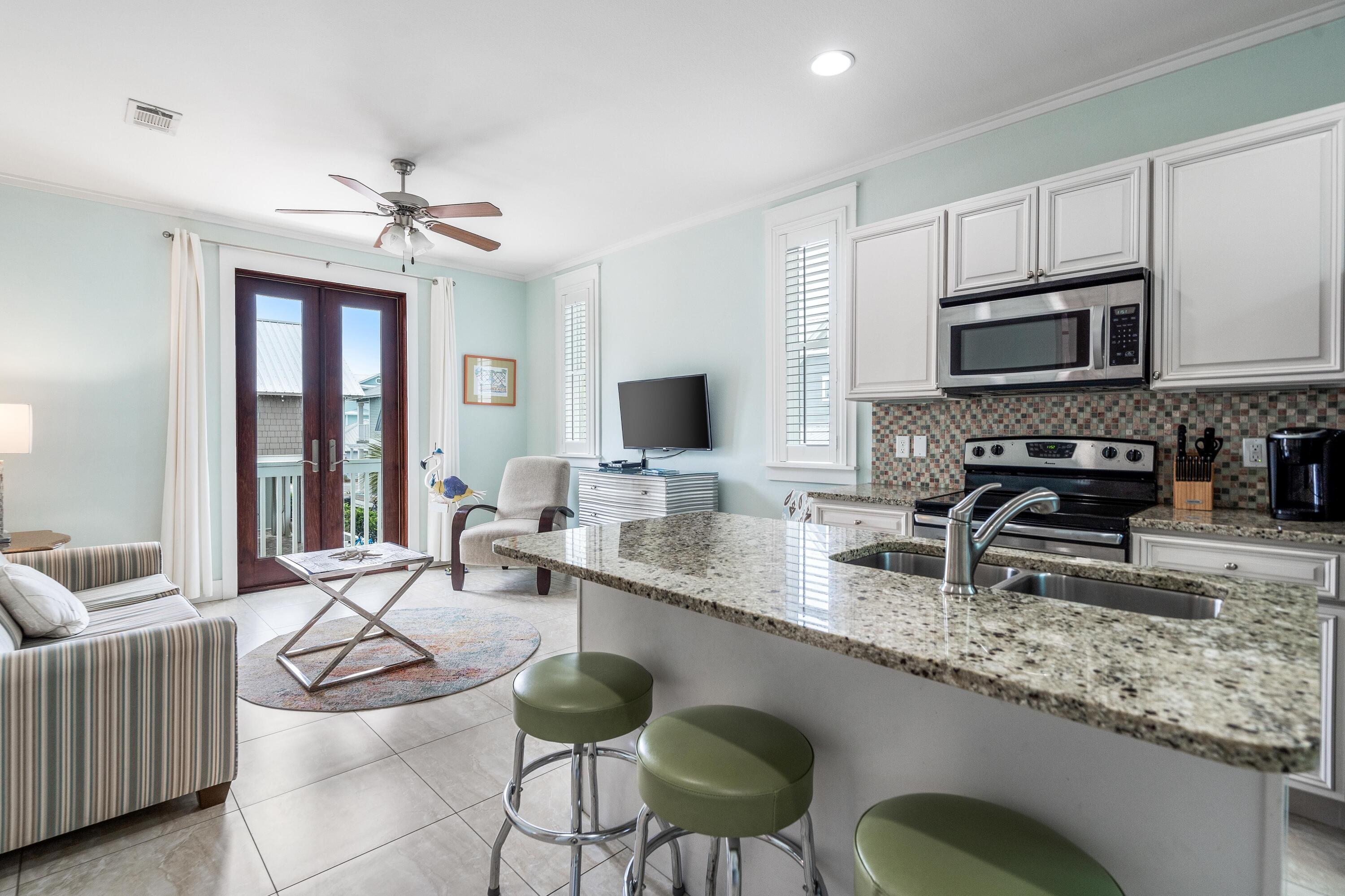 36 Moonlight Beach Lane Inlet Beach, FL 32461 - Photo 39 of 42 a kitchen with stainless steel appliances granite countertop a sink a stove a microwave counter space and cabinets