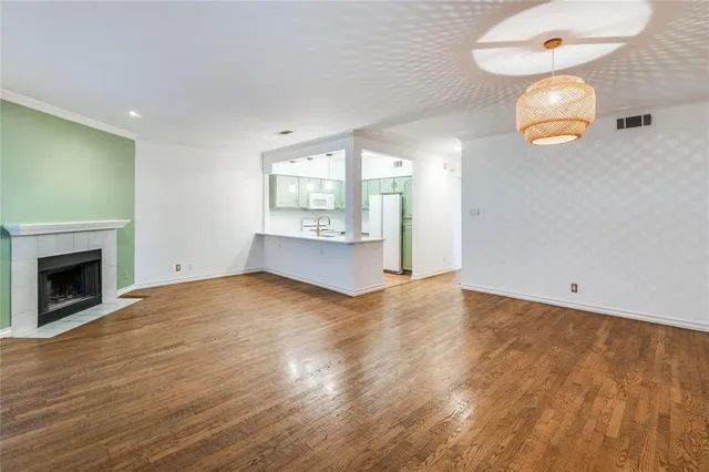 an empty room with windows and fireplace