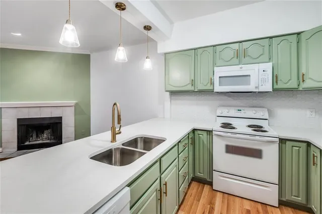 a view of an empty room with a fireplace and a window
