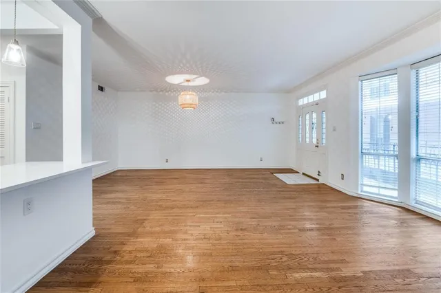 an empty room with wooden floor and fireplace