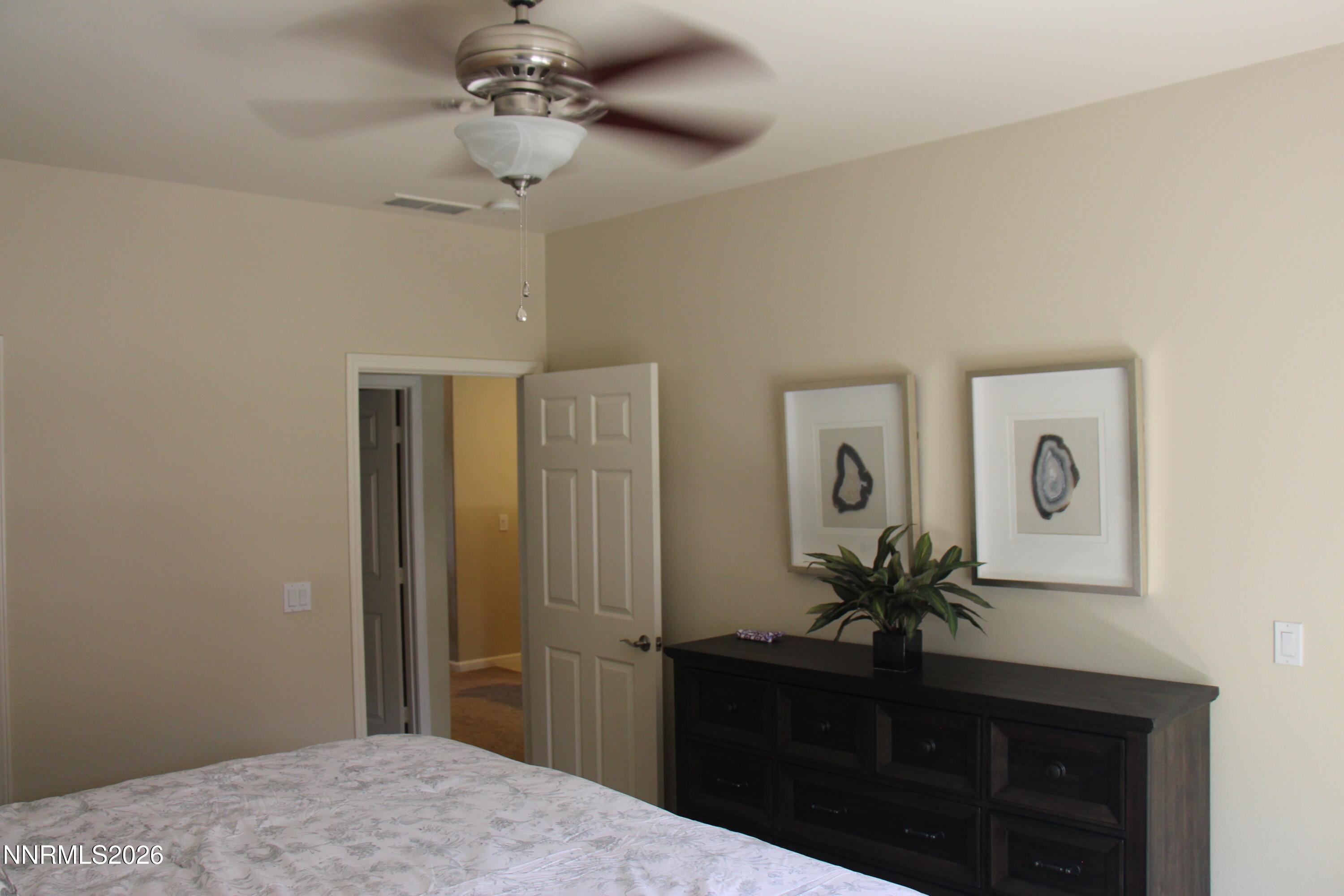 900 South Meadows Parkway, Unit 2122 Reno, NV 89521 - Photo 4 of 6 a bedroom with a bed and a dresser