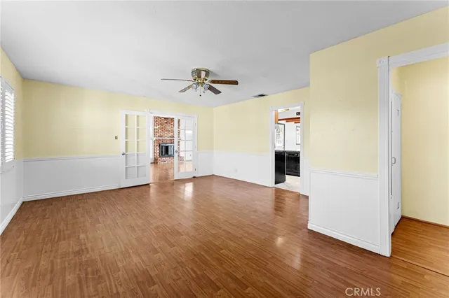 a view of a livingroom with wooden floor and staircase