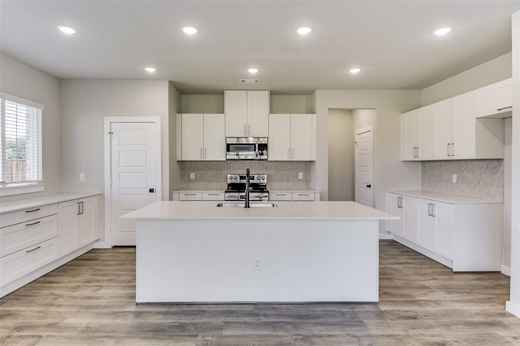 4220 Clovis Street Midlothian, TX 76065 - Photo 7 of 19 a view of kitchen with stainless steel appliances granite countertop a stove top oven a sink and white cabinets