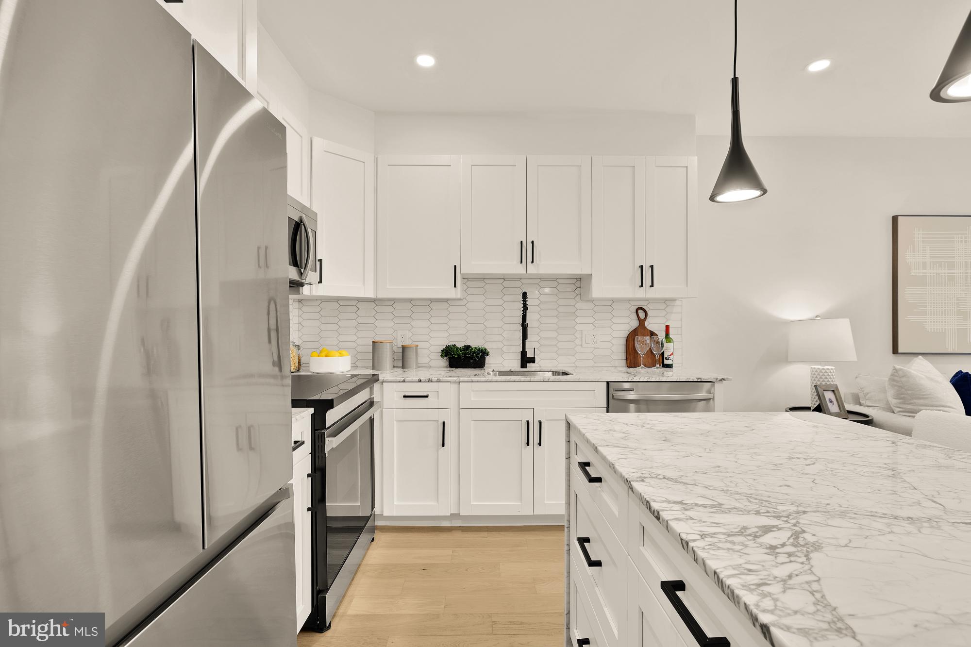 2606 41st Street Northwest, Unit 4 Washington, DC 20007 - Photo 11 of 25 a kitchen with stainless steel appliances granite countertop a sink stove and refrigerator