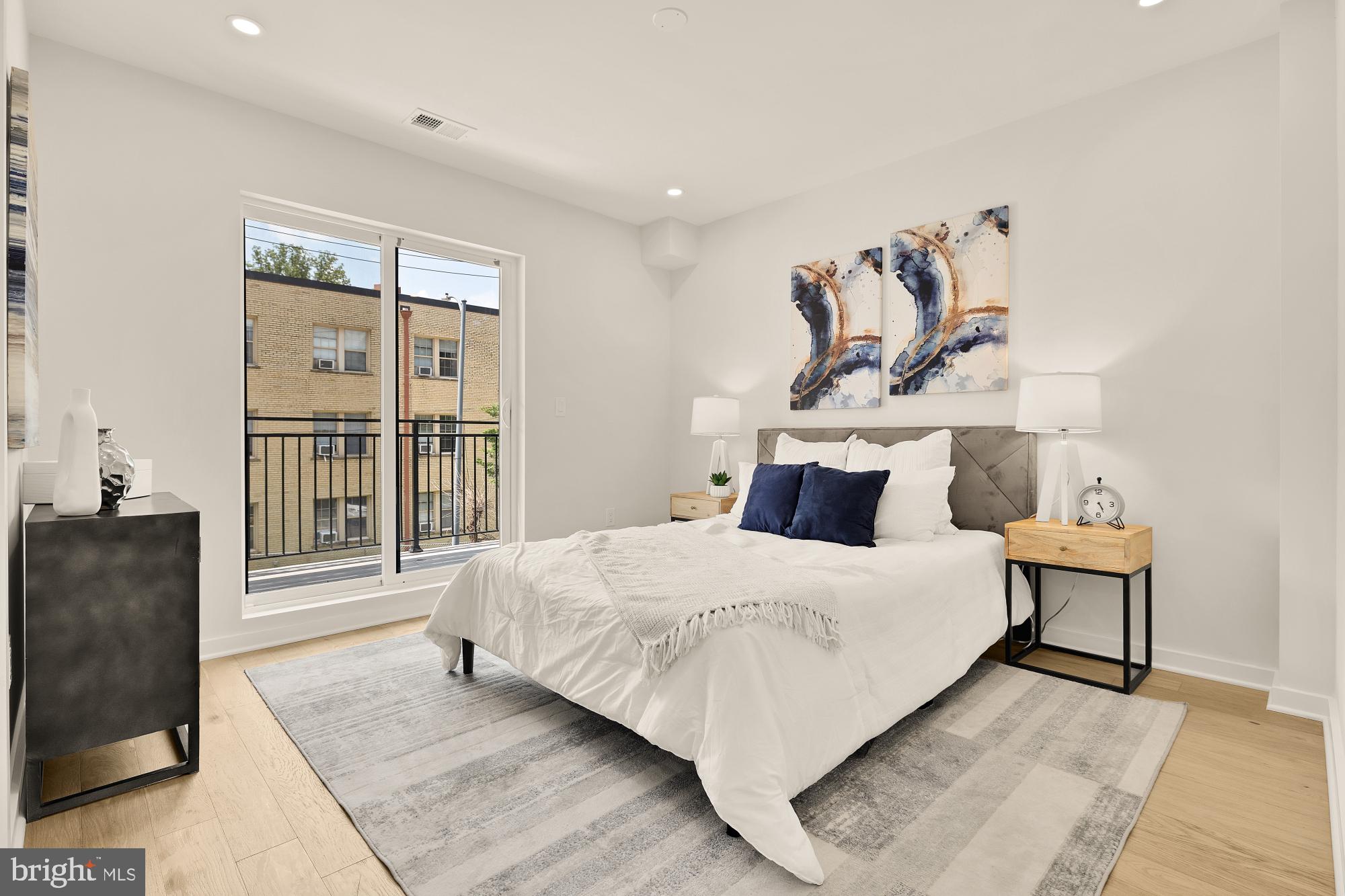 2606 41st Street Northwest, Unit 4 Washington, DC 20007 - Photo 13 of 25 a bedroom with a bed and wooden floor