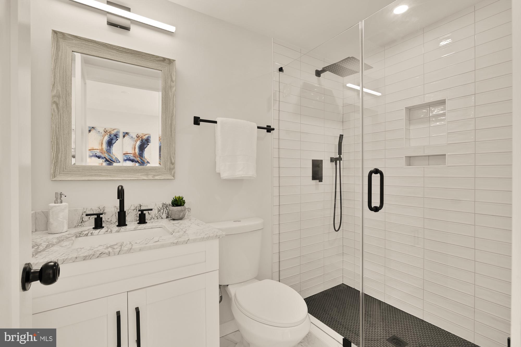 2606 41st Street Northwest, Unit 4 Washington, DC 20007 - Photo 16 of 25 a bathroom with a sink a toilet and shower