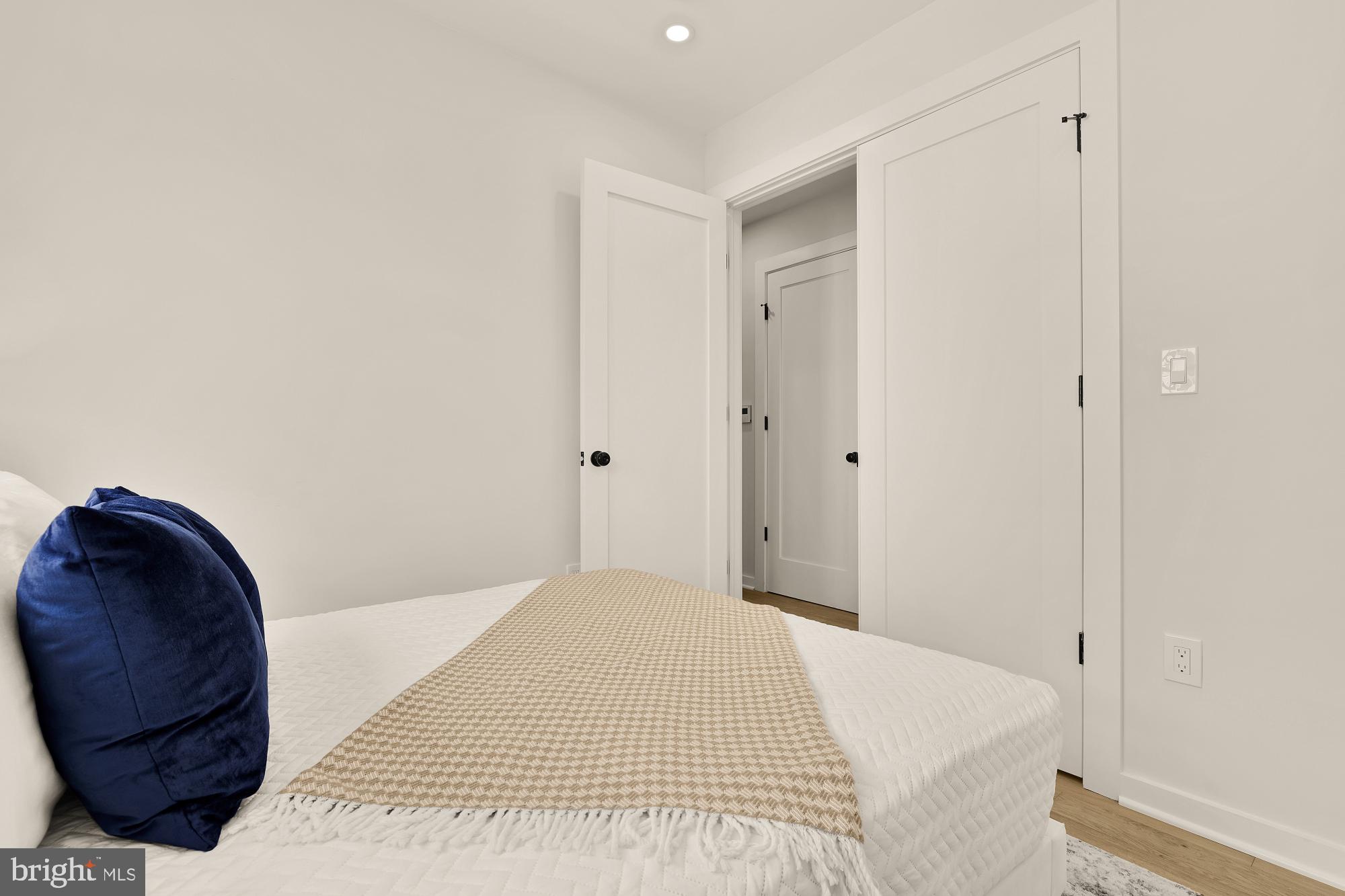2606 41st Street Northwest, Unit 4 Washington, DC 20007 - Photo 20 of 25 a bedroom with a bed and a mirror