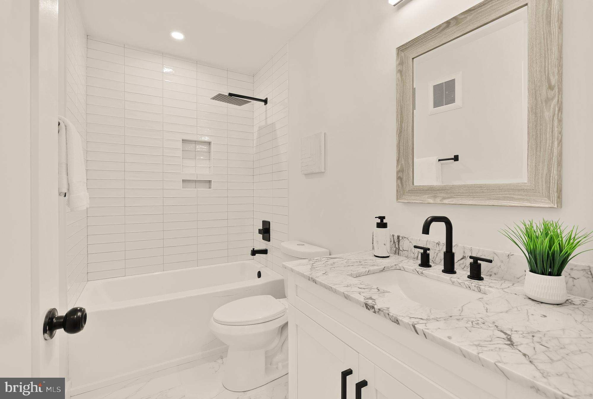 2606 41st Street Northwest, Unit 4 Washington, DC 20007 - Photo 21 of 25 a bathroom with a granite countertop sink a toilet and a bathtub
