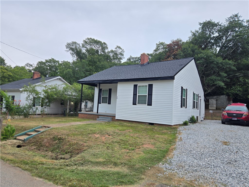 28 Ames Street Seneca, SC 29678 - Photo 19 of 22 Classic siding and dark shutters define this charming cottage with a gravel driveway.