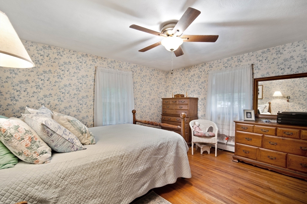 197 Hazardville Road Longmeadow, MA 01106 - Photo 14 of 37 a bedroom with a bed and a chandelier