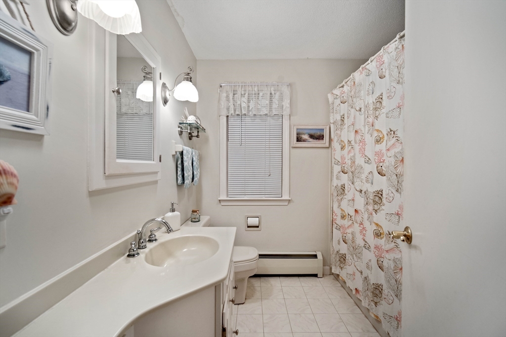 197 Hazardville Road Longmeadow, MA 01106 - Photo 17 of 37 a bathroom with a sink a mirror a vanity and a shower