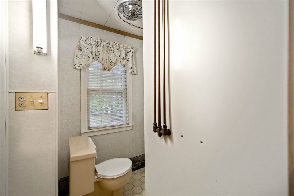 197 Hazardville Road Longmeadow, MA 01106 - Photo 25 of 37 a bathroom with a toilet and a shower curtain