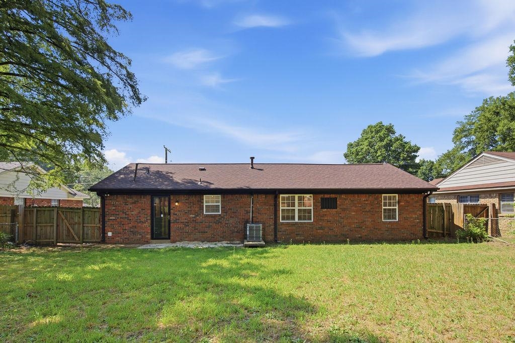 1304 Winfield Road Memphis, TN 38116 - Photo 18 of 19 Brick exterior with multiple windows and a brown shingle roof