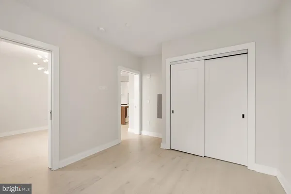 a view of an empty room and closet area