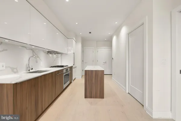 a kitchen with granite countertop a sink and cabinets